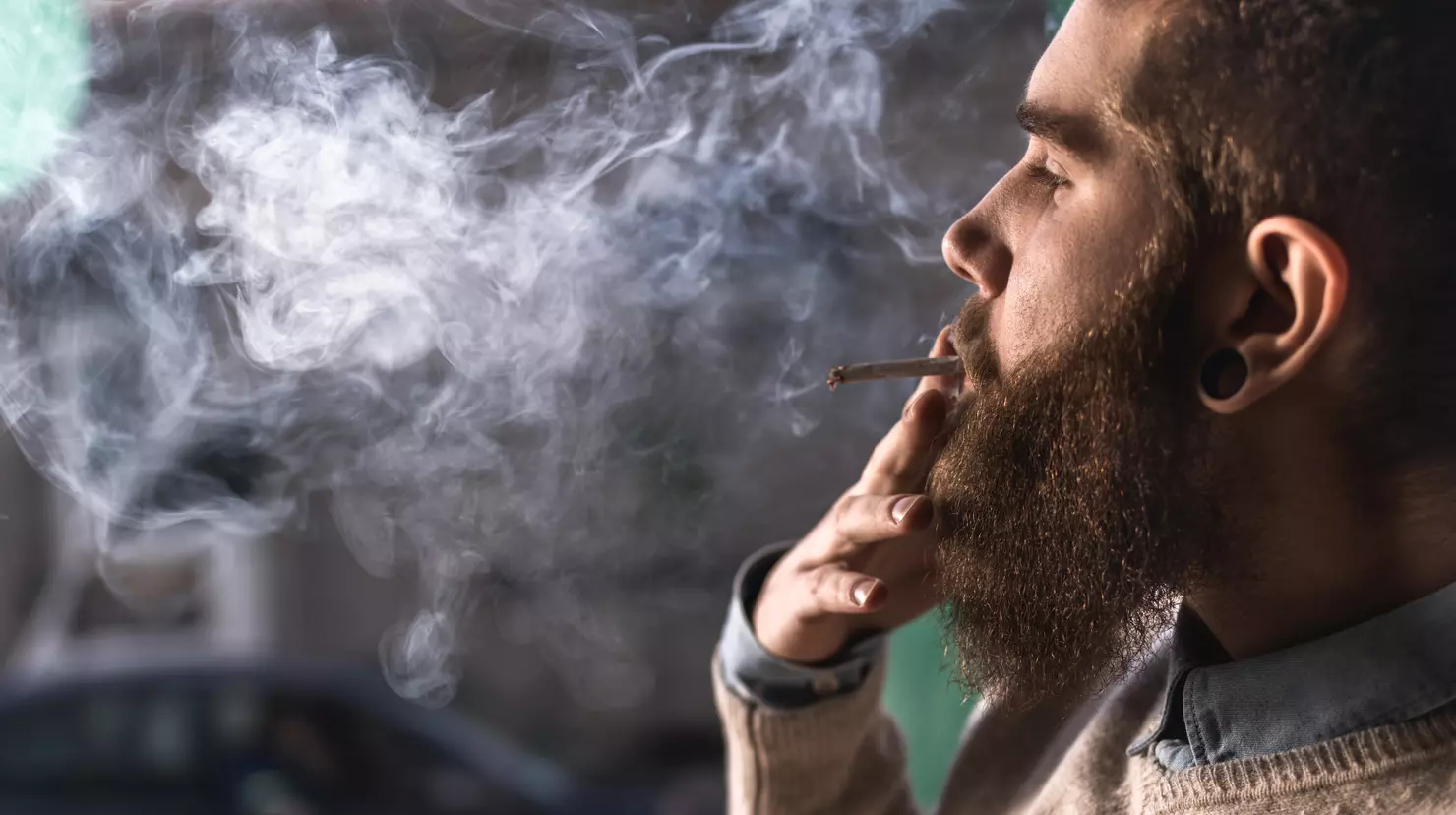 a man smoking in a room